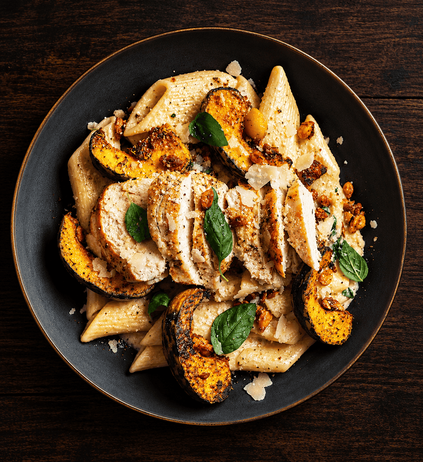 Large penne pasta with roasted curry pumpkin, baby spinach and creamy Parmesan sauce, a recipe by chef Paul Watters.