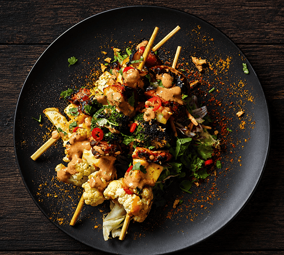 Smoky chicken and vegetable skewers with cauliflower, broccoli, red pepper and onion, served with salad and creamy yoghurt dressing.
