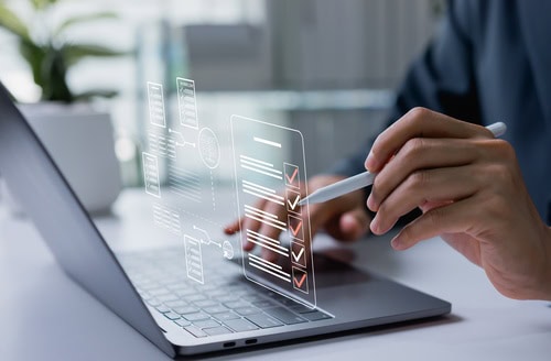 Person using a laptop to organise and automate financial tasks, payments and regular money management.